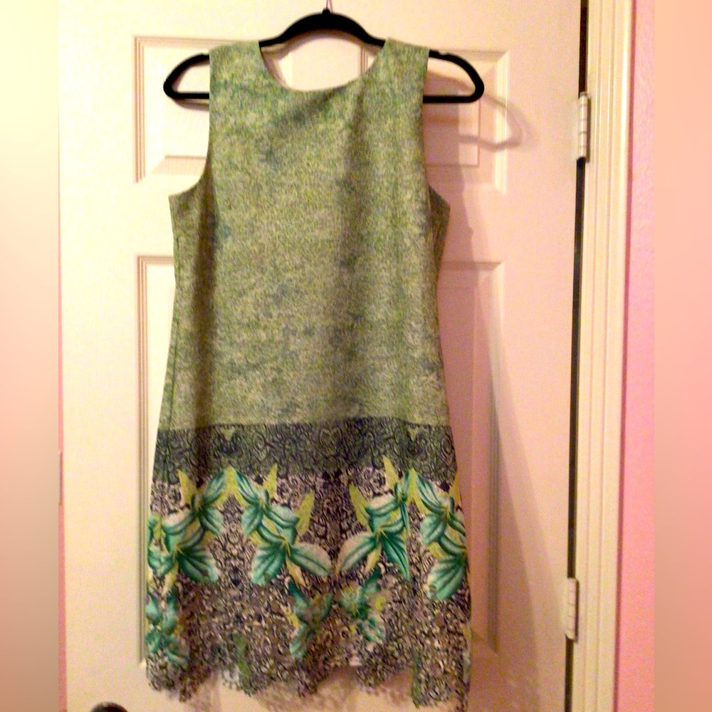 Perfect summer dress.  Sleeveless and intricate details at hem.